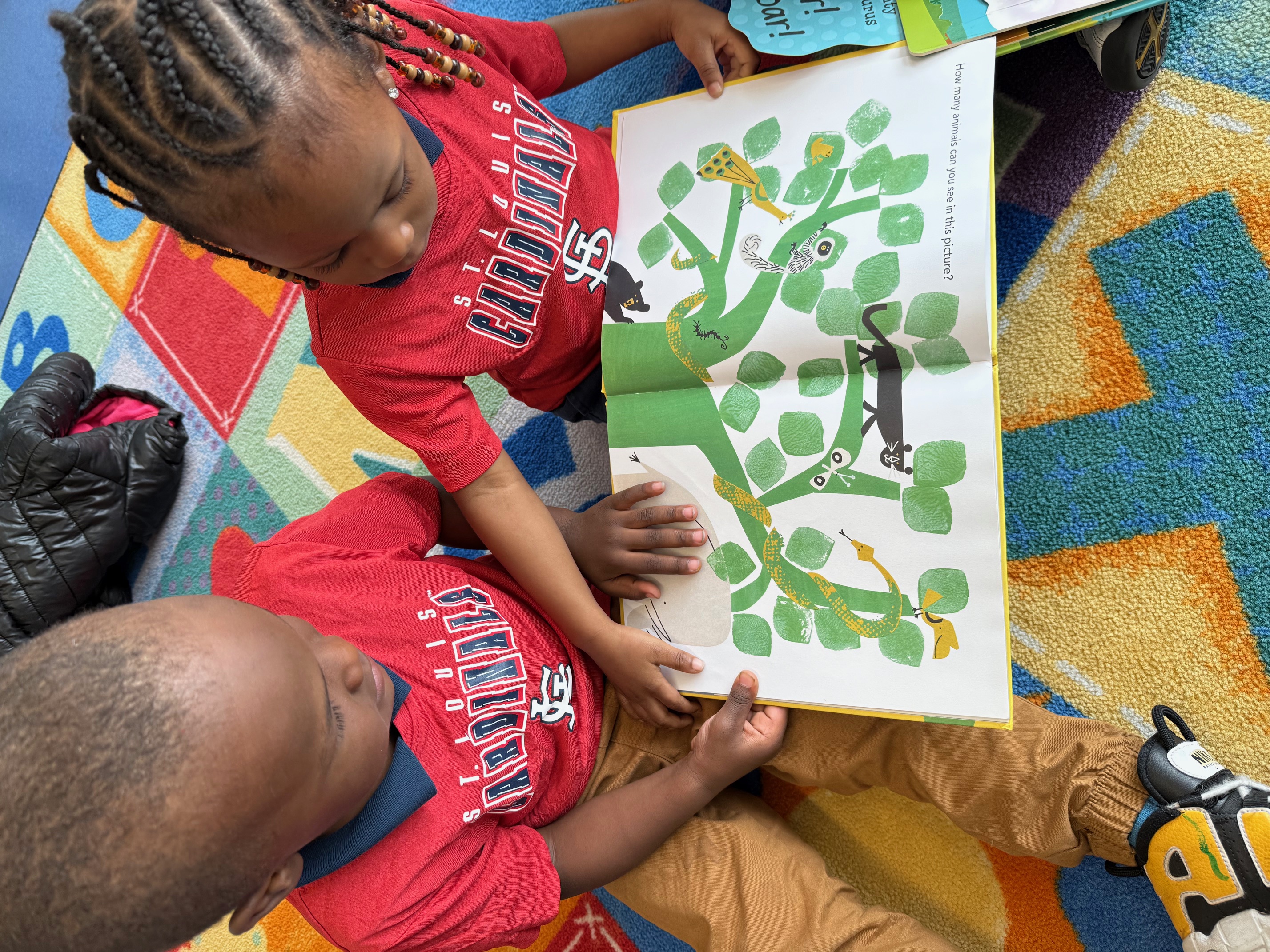 Children reading together at Scholar Academy childcare in St. Ann Missouri